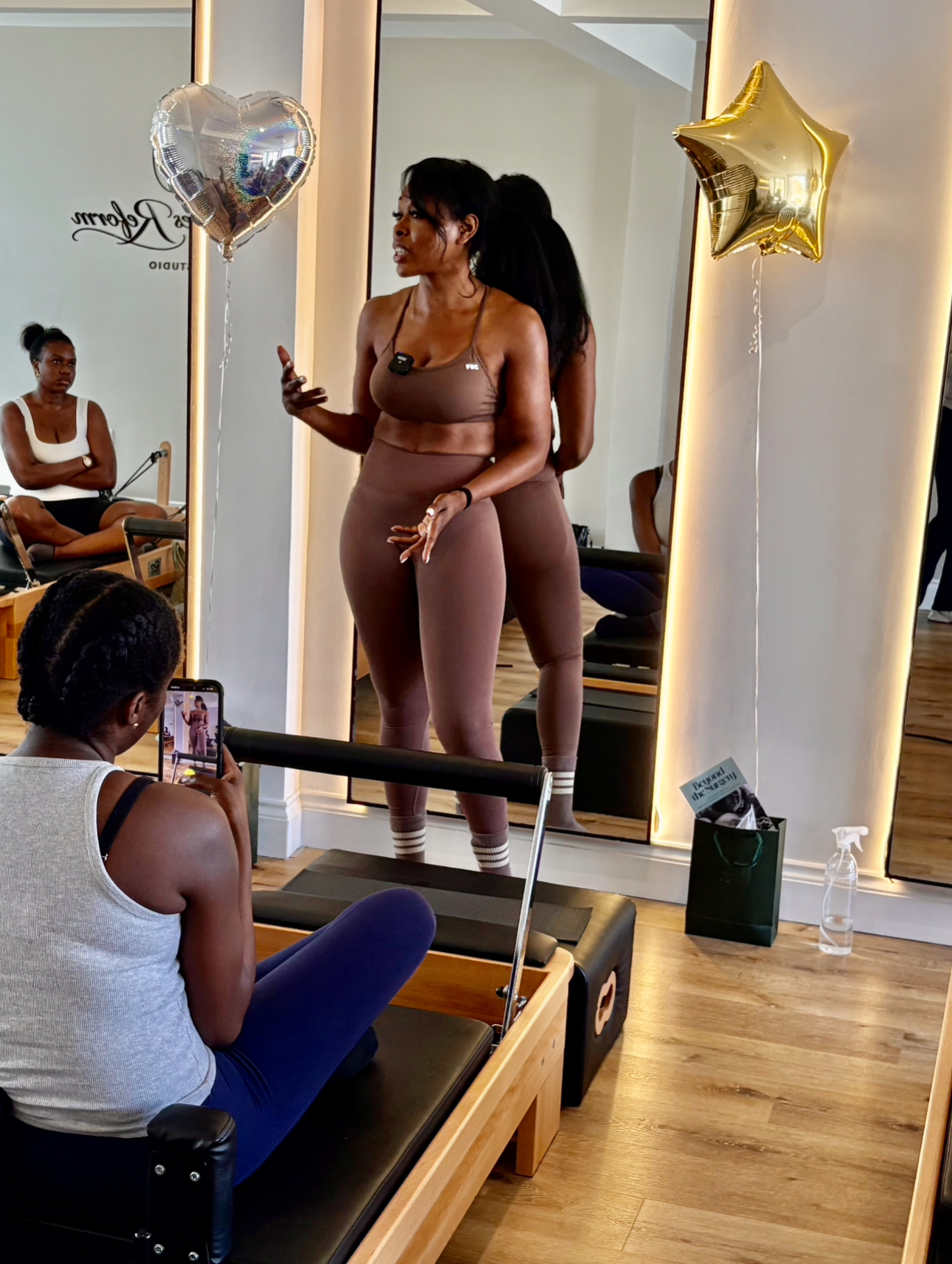 Nina coaching women in the reformer studio